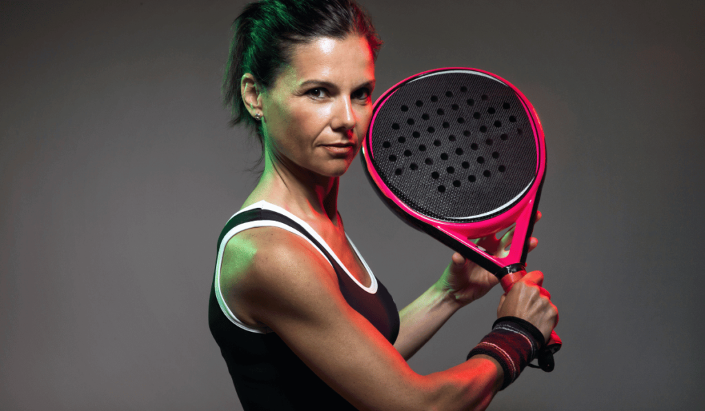 holding a pink padel racket